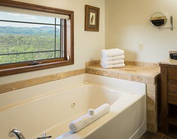 jetted tub with White fluffy towels, widow over the tub with  a view of  the Valley